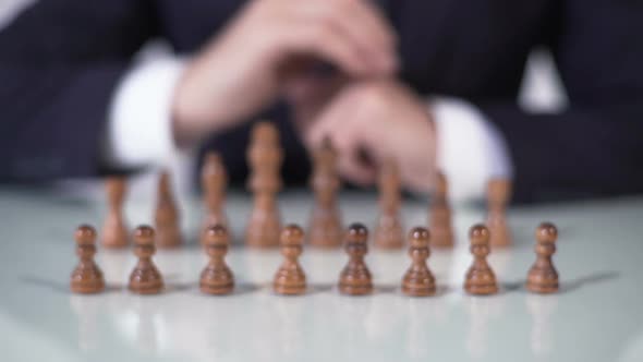 Player Sacrificing Pawn in Chess Game, Startup Company Entering Large Market