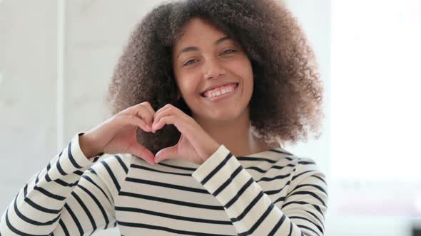 African Woman Showing Heart Sign with Hand