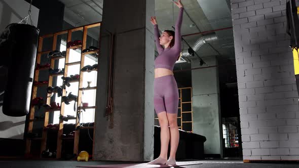 Young Woman Playing with a Jumping Rope in the Gym