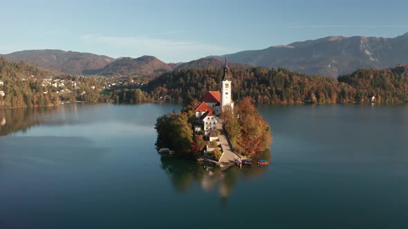 Amazing Aerial View of the Colorful Forest and Lake Bled with a Small Island with a Church. Sunrise