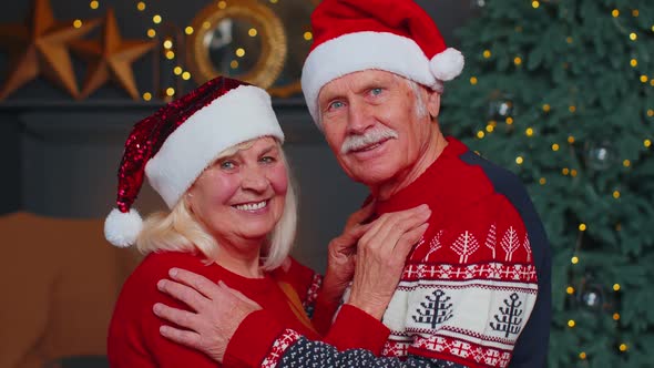 Smiling Married Senior Couple Grandparents Man Woman in Living Room Celebrating Christmas Together