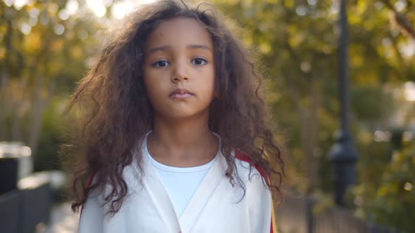 Portrait of Beautiful Mixed Race Kid on Landscape Background