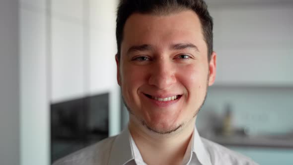 Close up portrait of person looking at camera smiling and laughing