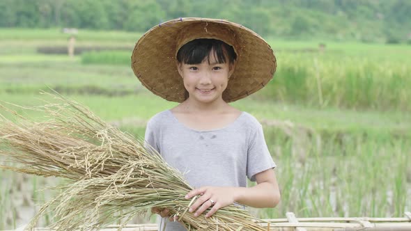 Cute Girl Farmer Smiling In Rice Field