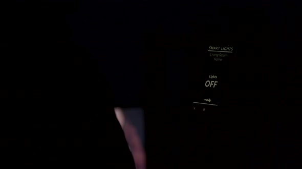 Close Up of Man Using a Voice Activated Application To Turn on the Lights in the House