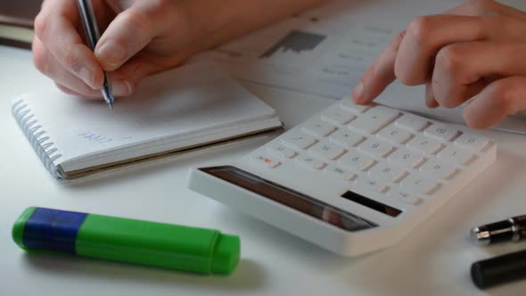 A Businessman Working in Calculator