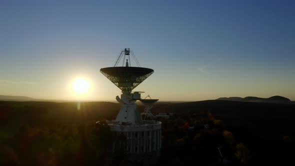 Aerial Drone Shot of Telecommunications Antenna or Radio Telescope Satellite Dish on Sunset