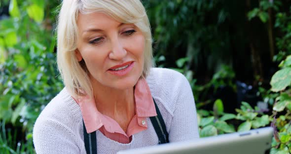 Mature woman using digital tablet