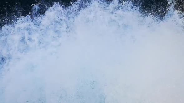 Impressive closeup of a large ship bow moving forward and cutting the foamy sea waves