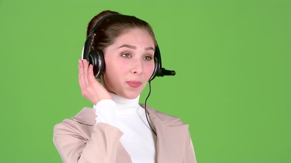 Support Worker Speaks To Customers on the Headset. Green Screen. Slow Motion