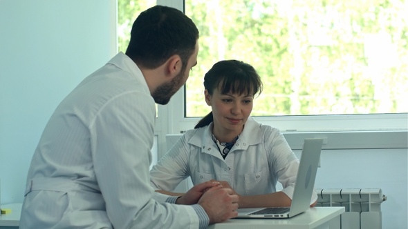 Young doctors working with a laptop in an office