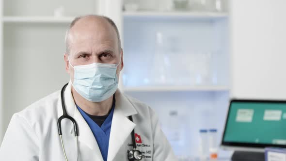 Doctor wearing face mask turning and looking at camera