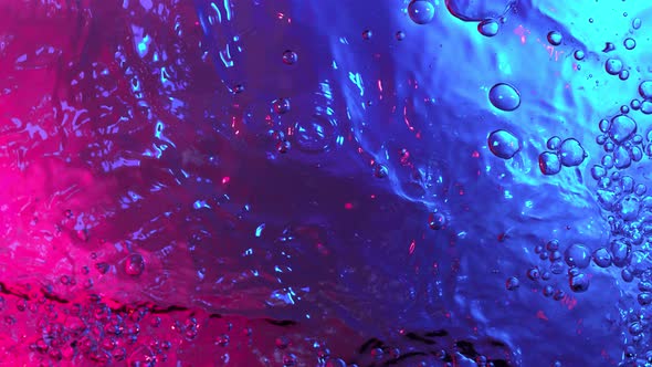 Super Slow Motion Abstract Shot of Swirling Neon Water at 1000Fps