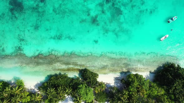 Wide angle above abstract shot of a white sand paradise beach and blue sea background 