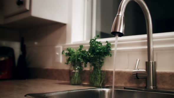 Man Filling a Glass of Water Before to Go to Bed