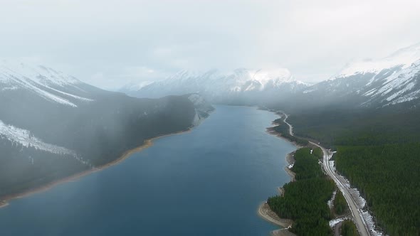 Aerial video footage shows a light fog over Spray Lakes Reservoir in Alberta, Canada