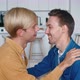 Portrait of Two Happy Men Gay Couple in Love Kissing in Make a Gentle Headbutt While Sitting on Sofa - VideoHive Item for Sale