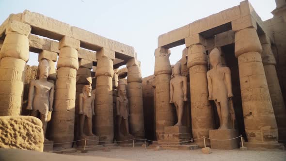 Tall pillars and pylons with rock statues in the Karnak Temple, Luxor, Egypt. Slow camera movement