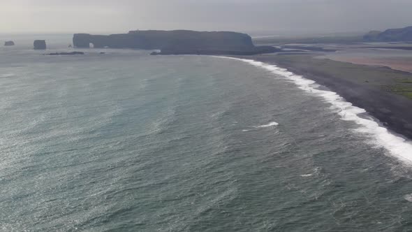 Aerial view of Dyrholaey peninsula and Reynisfjara black sand beach in Iceland