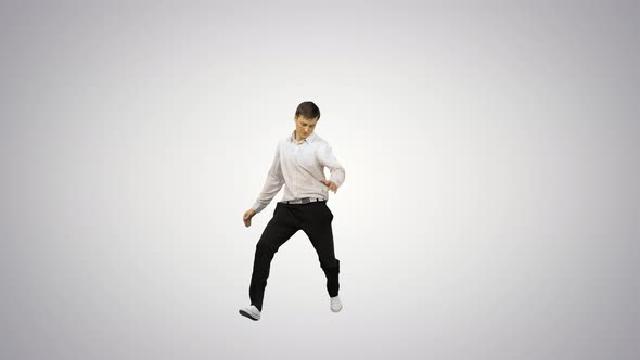 Young Man Dressed in White Shirt and Black Pants Jumping in the Frame and Starting To Dance Break