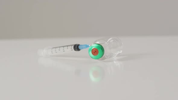 Video of close up of vaccine vial on white background