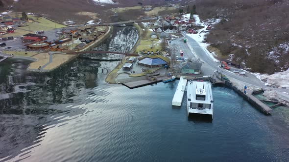 Passenger catamaran Vision of the fjords manoeuvering to port in Gudvangen Norway - Static aerial lo