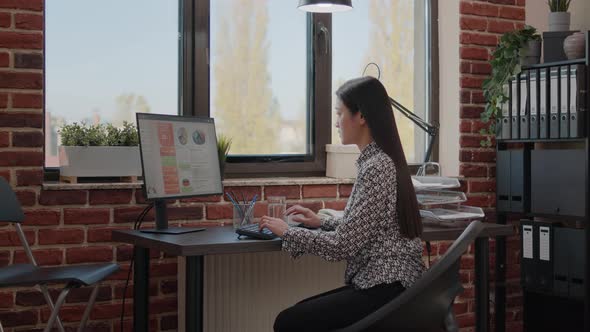 Business Woman Suffering From Back Pain and Working on Computer