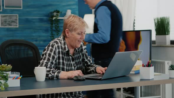 Old Woman Receving Good News on Laptop Working From Home