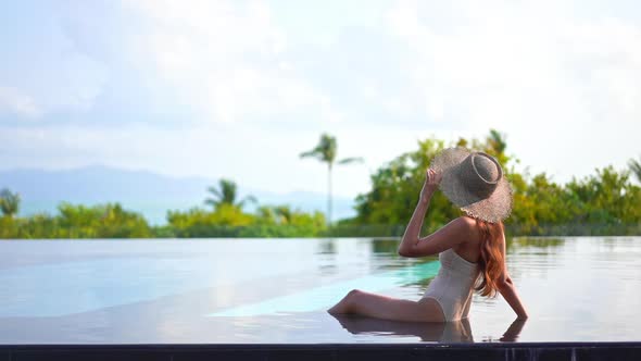 Young asian woman enjoy around outdoor swimming pool for leisure