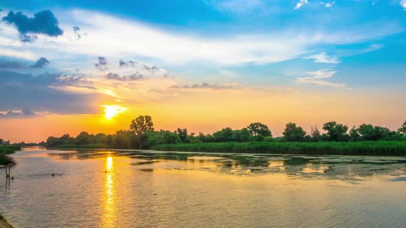 Beautiful Sunset Cloudy Sky over the River with Rain