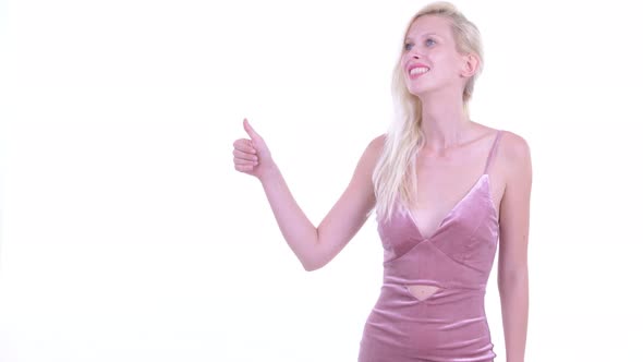 Happy Young Blonde Woman Snapping Fingers and Giving Thumbs Up