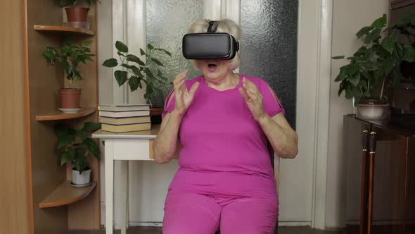 Senior Grandmother Putting on Virtual Headset Glasses and Watching 3d Video in 360 Vr Helmet at Home