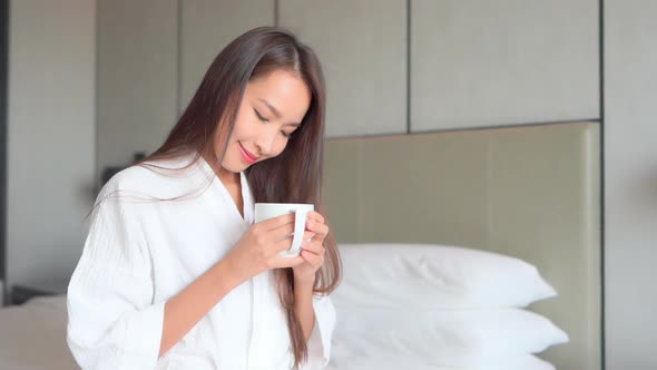 Young asian woman with coffee cup