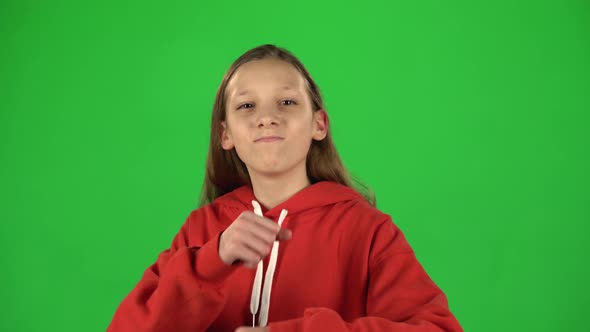 Girl Feeling Happy and Satisfied Showing Yeah in Studio on Green Background.