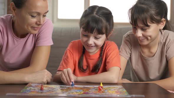 Children and mother by game table.