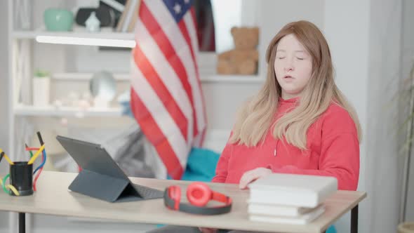 Portrait of Overworked Asian Teen Girl Yawning and Putting Head on Table