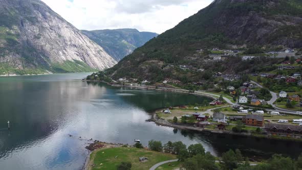 Eidfjord seafront view - Sidewaysing aerial with eidfjord river and Simadalen valley in background