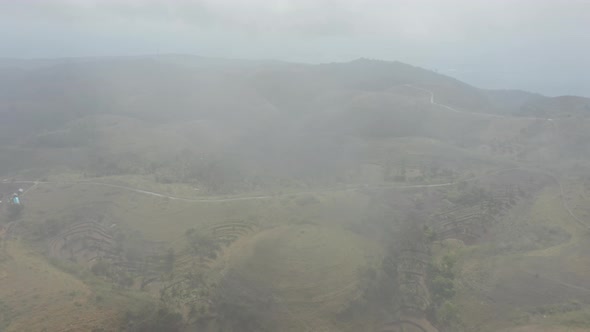 Panoramic Shot of Lush Hills in Bali, Indonesia Revealed Behind Foggy Sky