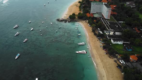 Beautiful cinematic Sanur beach, Bali drone footage with interesting landscape, fishing boats, hotel