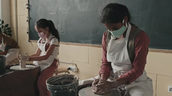 Girl in Mask Making Craft of Clay