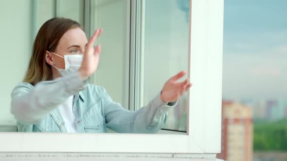 Woman Applauds on the Balcony of Her Apartment, Thanking the Medical Services for Covid-19