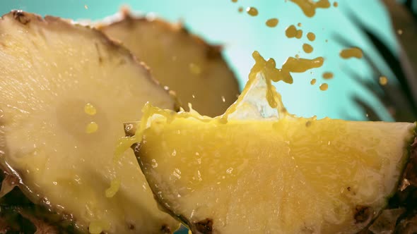 Slow Motion Shot of Pineapple and Juice Splashing Through Pineapple Slices