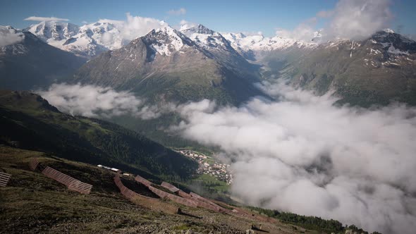 timelapse of a layer of morning fog dissolving above Pontresina seen from Segantini hut with views o