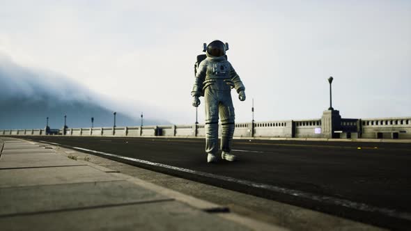 Astronaut in Space Suit on the Road Bridge alt