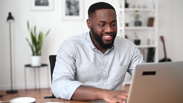 An African Guy Is Using Laptop for Work