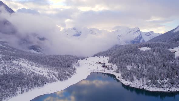 Oeschinen Lake in Switzerland Surrounded by Snow Covered Forests and Mountains