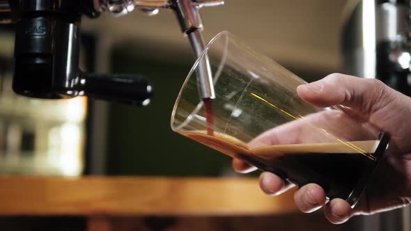 Barman Pouring Nitrogen Beer Into Glass Closeup