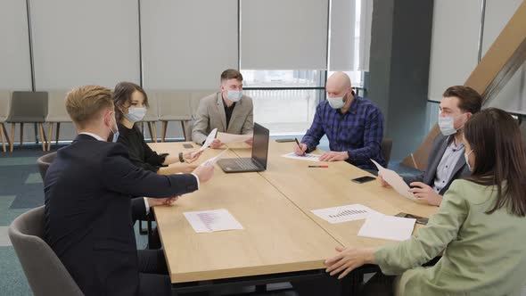 Business People Having a Meeting Working in the Office Wearing Medical Mask