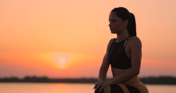 Woman is Making Lunges and Crouching Outdoors Training Her Body