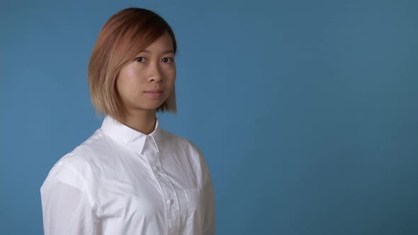 Portrait Young Asian Female on Blue Background in Studio